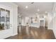 Bright, open-concept living area leading into a kitchen, featuring hardwood floors and recessed lighting at 146 Birch Tree Way, Cumming, GA 30040