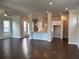 Open floor plan with dark hardwood floors, white columns, and a modern kitchen at 146 Birch Tree Way, Cumming, GA 30040
