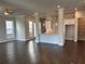 Spacious living room with large windows, hardwood floors, ceiling fan, and a view of the kitchen at 146 Birch Tree Way, Cumming, GA 30040