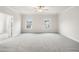 Large main bedroom with carpeted floors, a ceiling fan, and natural light from two windows at 146 Birch Tree Way, Cumming, GA 30040