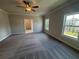 Spacious main bedroom with plush carpet, a ceiling fan, and natural light from two windows at 146 Birch Tree Way, Cumming, GA 30040