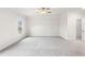 An expansive main bedroom with carpeted floors, a ceiling fan, and a walk-in closet at 146 Birch Tree Way, Cumming, GA 30040