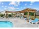 Community pool featuring lounge chairs, a covered pergola, and beautiful landscaping at 146 Birch Tree Way, Cumming, GA 30040
