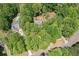 Aerial shot features a home surrounded by beautiful, mature trees, with a nearby pool at 160 Wentworth Dr, Canton, GA 30114