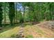 A serene backyard features a lush lawn with stepping stones leading to a shed at 160 Wentworth Dr, Canton, GA 30114