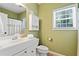 Bright bathroom features a white sink, medicine cabinet, and window for natural light at 160 Wentworth Dr, Canton, GA 30114