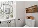 Charming half bathroom featuring modern vanity, floral wallpaper, and a rustic wooden sign at 160 Wentworth Dr, Canton, GA 30114