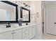 Bright bathroom featuring double sinks, white countertops, framed mirrors, and modern lighting at 160 Wentworth Dr, Canton, GA 30114