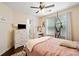 Cozy bedroom featuring hardwood floors, a ceiling fan, and plenty of natural light at 160 Wentworth Dr, Canton, GA 30114