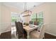 Formal dining room features modern lighting, wainscoting, and hardwood floors at 160 Wentworth Dr, Canton, GA 30114