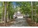 Beautiful home nestled among trees with a long driveway leading to a two-car garage at 160 Wentworth Dr, Canton, GA 30114