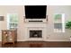Close up of living room fireplace with white mantle and adjacent built-in cabinet with shelves at 160 Wentworth Dr, Canton, GA 30114
