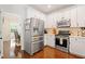 This kitchen is complete with stainless steel appliances and ample white cabinet storage at 160 Wentworth Dr, Canton, GA 30114