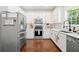 Well-lit kitchen showcases stainless steel appliances, white cabinets, and hardwood floors at 160 Wentworth Dr, Canton, GA 30114