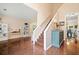 Bright open-concept living room and staircase with beautiful hardwood floors and neutral decor at 160 Wentworth Dr, Canton, GA 30114