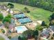 Community amenities abound: tennis courts, playground, pool, green spaces in an aerial view at 1900 Chattahoochee Run Dr, Suwanee, GA 30024