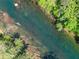 Aerial view of a serene, tree-lined river with clear, flowing water at 1900 Chattahoochee Run Dr, Suwanee, GA 30024