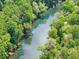Scenic aerial view captures a tranquil river winding through a lush, green landscape at 1900 Chattahoochee Run Dr, Suwanee, GA 30024