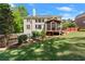 Beautiful backyard featuring a spacious lawn, a screened porch, and lush greenery at 1900 Chattahoochee Run Dr, Suwanee, GA 30024