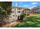 Backyard with a patio, a screened porch, and a large lawn at 1900 Chattahoochee Run Dr, Suwanee, GA 30024