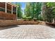 An open backyard with a stone tile patio and a deck at 1900 Chattahoochee Run Dr, Suwanee, GA 30024