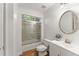 Bathroom featuring tub with shower, modern vanity, and neutral color scheme at 1900 Chattahoochee Run Dr, Suwanee, GA 30024