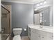 Bright bathroom featuring vanity with storage, large mirror, and glass shower door at 1900 Chattahoochee Run Dr, Suwanee, GA 30024