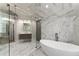 Bright, spacious marble bathroom with a glass shower, soaking tub, and modern fixtures at 1900 Chattahoochee Run Dr, Suwanee, GA 30024