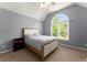 Cozy bedroom with large arched window, neutral carpet, and ample natural light at 1900 Chattahoochee Run Dr, Suwanee, GA 30024