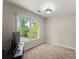 Bright bedroom with a large window offering a pleasant view of the outdoors at 1900 Chattahoochee Run Dr, Suwanee, GA 30024