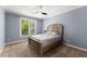 Comfortable bedroom with a ceiling fan and a bright window, allowing for natural light at 1900 Chattahoochee Run Dr, Suwanee, GA 30024
