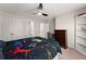 Bedroom featuring a ceiling fan, carpet, closet, and desk area at 1900 Chattahoochee Run Dr, Suwanee, GA 30024