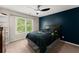 Modern bedroom with accent wall, ceiling fan, and comfortable bed at 1900 Chattahoochee Run Dr, Suwanee, GA 30024