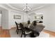 Charming dining room with chandelier lighting, and wainscoting, perfect for entertaining at 1900 Chattahoochee Run Dr, Suwanee, GA 30024
