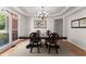 Elegant dining room featuring a chandelier, large windows, and traditional wainscoting detail at 1900 Chattahoochee Run Dr, Suwanee, GA 30024