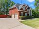 Lovely brick home with a three-car garage and a well-manicured lawn at 1900 Chattahoochee Run Dr, Suwanee, GA 30024