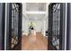 Grand foyer with hardwood floors, wrought iron door, and a view of the staircase and living area at 1900 Chattahoochee Run Dr, Suwanee, GA 30024
