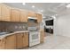 This kitchen features light wood cabinets, modern appliances, and tiled flooring at 1900 Chattahoochee Run Dr, Suwanee, GA 30024