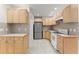 This kitchen features light wood cabinets, modern appliances, and tiled flooring at 1900 Chattahoochee Run Dr, Suwanee, GA 30024