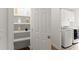 Bright laundry room with storage pantry and newer front load washer and dryer at 1900 Chattahoochee Run Dr, Suwanee, GA 30024