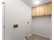 Bright laundry room featuring built-in storage cabinets and washer/dryer hookups at 1900 Chattahoochee Run Dr, Suwanee, GA 30024