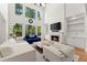 Bright living room with a fireplace, hardwood floors, large windows, and neutral-colored furnishings at 1900 Chattahoochee Run Dr, Suwanee, GA 30024