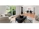 Elegant living room flows into the dining room; features hardwood floors and a large bright window at 1900 Chattahoochee Run Dr, Suwanee, GA 30024