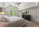 This spacious main bedroom has a ceiling fan, a large window, and neutral decor at 1900 Chattahoochee Run Dr, Suwanee, GA 30024