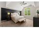 Main bedroom featuring a large bed, ceiling fan, neutral decor, and a large window at 1900 Chattahoochee Run Dr, Suwanee, GA 30024