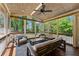 Relaxing screened porch featuring wood ceiling, comfortable seating, and view of the wooded backyard at 1900 Chattahoochee Run Dr, Suwanee, GA 30024