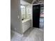 Modern bathroom featuring marble tile floors, granite countertops, and dark accents at 370 Buchanan Circle Tract 1, Dallas, GA 30157