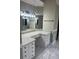 Bathroom vanity features granite counters, ample cabinet space, modern lighting, and tile flooring at 370 Buchanan Circle Tract 1, Dallas, GA 30157