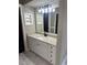 Stylish bathroom with granite countertops, white cabinetry, a sleek mirror, and modern lighting at 370 Buchanan Circle Tract 1, Dallas, GA 30157