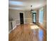 Dining room featuring wood flooring, wainscotting, a modern light fixture, and multiple windows providing natural light at 370 Buchanan Circle Tract 1, Dallas, GA 30157